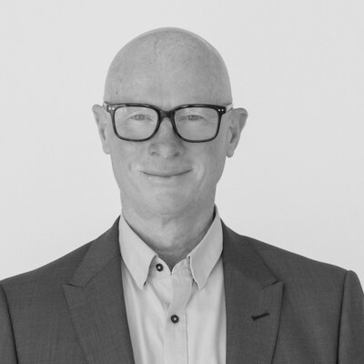 Black and white headshot of Chris Simpson looking directly at the camera