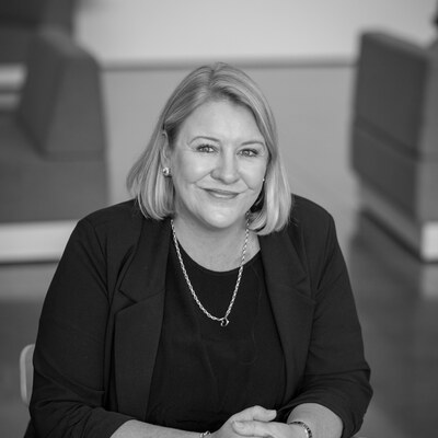Black and white headshot of Dani Simpson smiling at the camera