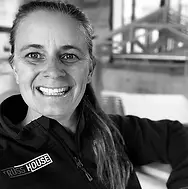 Black and white image of Pamela smiling wearing a Truss House jumper